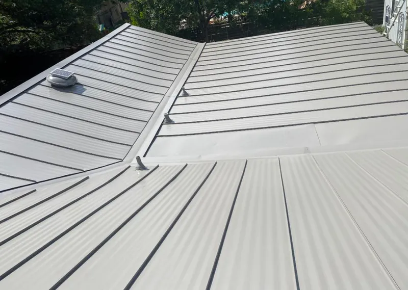Solar attic fan installed on a metal roof for Roof Ventilation in Metuchen