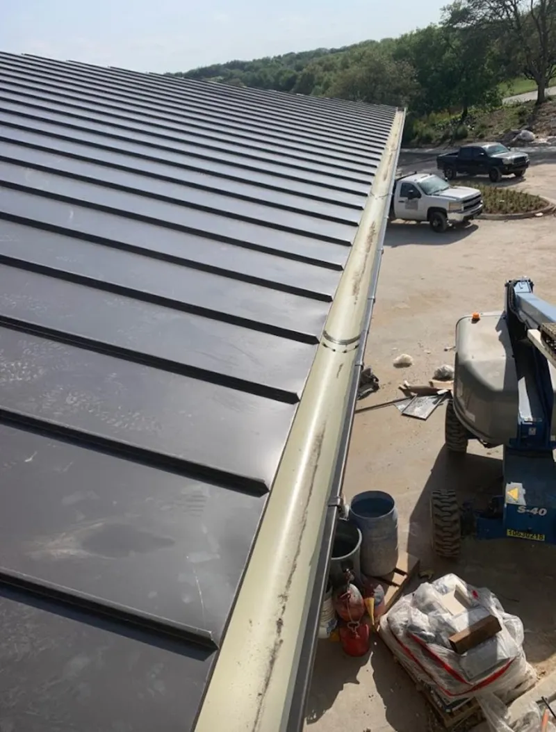 Standing seam panel and gutter detail on a metal roofing jobsite in Metuchen